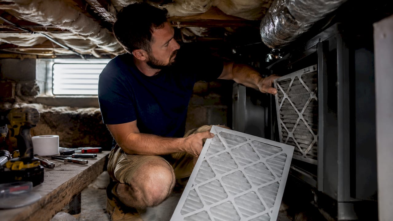 Homeowner changing HVAC air filter