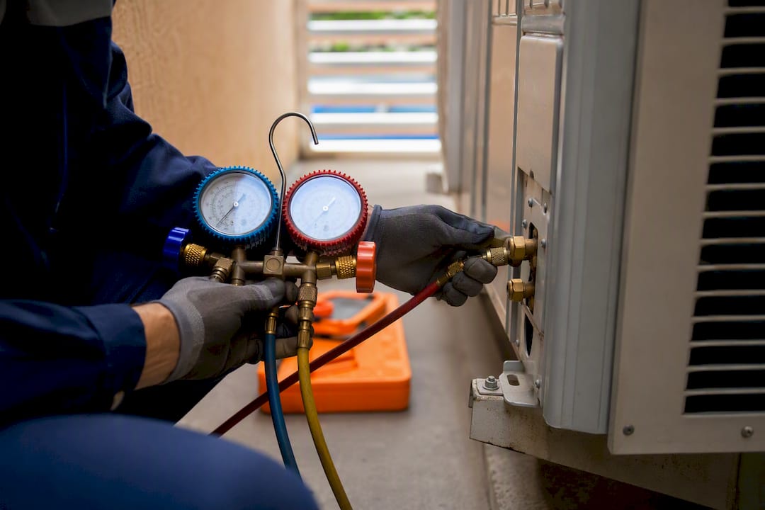 AC Maintenance Cost: $70–$350 Per Visit, U.S. Homeowners and LA Tips ac maintenance cost ac maintenance cost 1788007295329 Technician connecting gauges for refrigerant service Technician connecting gauges for refrigerant service